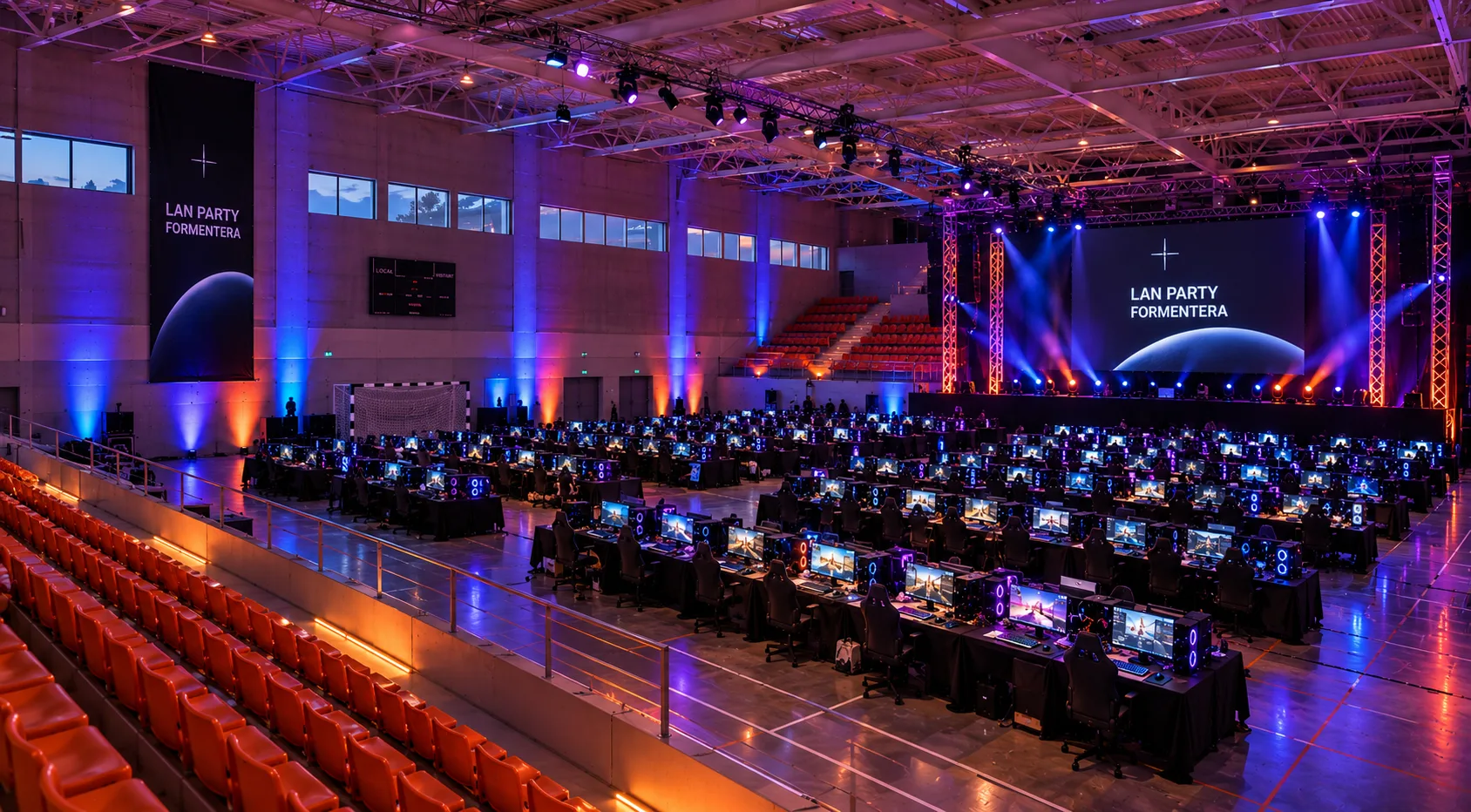 Vista desde las gradas de la pista convertida en LAN party, con un escenario y una gran pantalla iluminados.